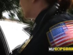 Black suspect is apprehended by two MILFs with big boobs wearing uniforms.